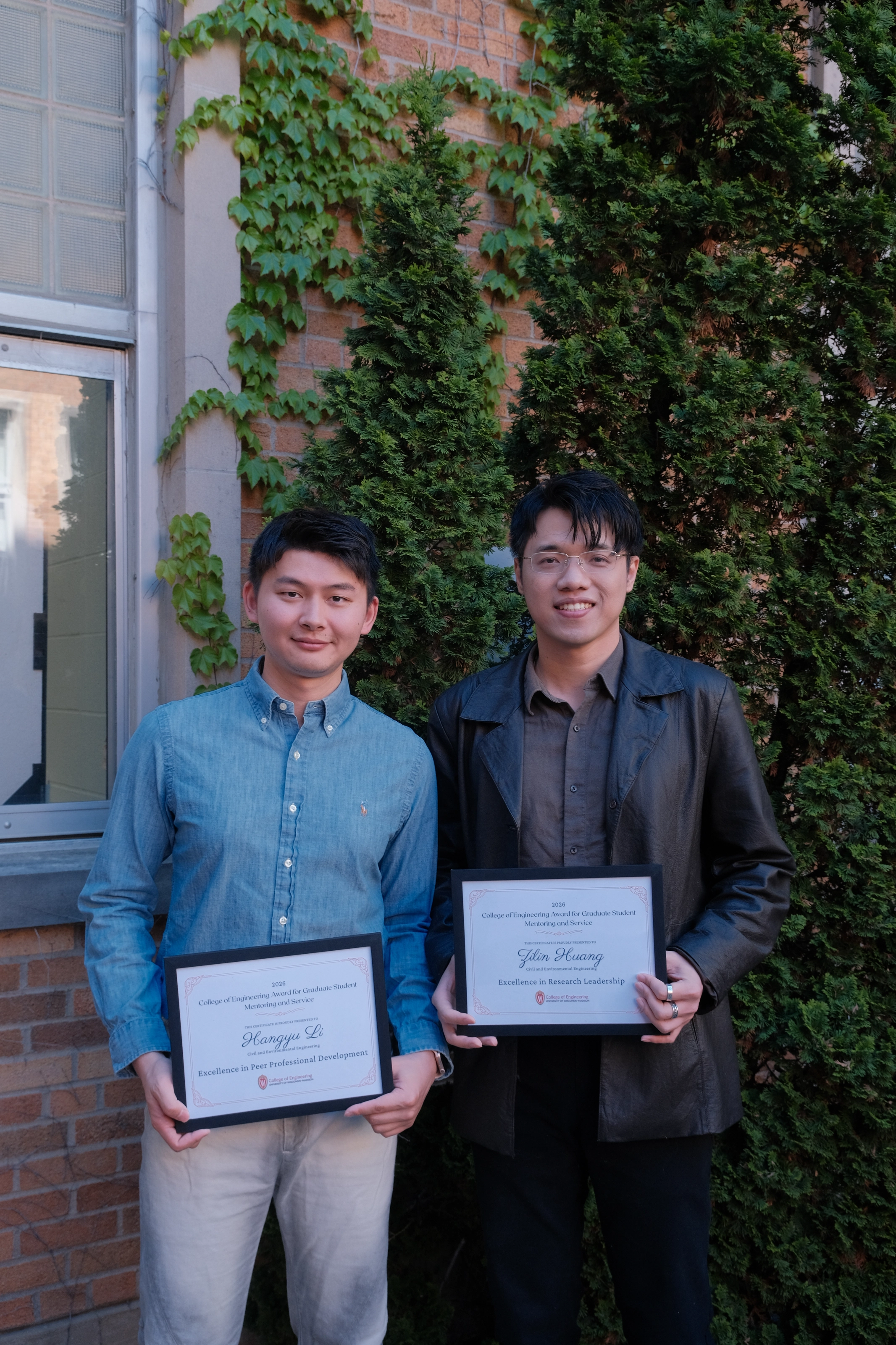Zilin Huang celebrating the mentoring award with a fellow award recipient