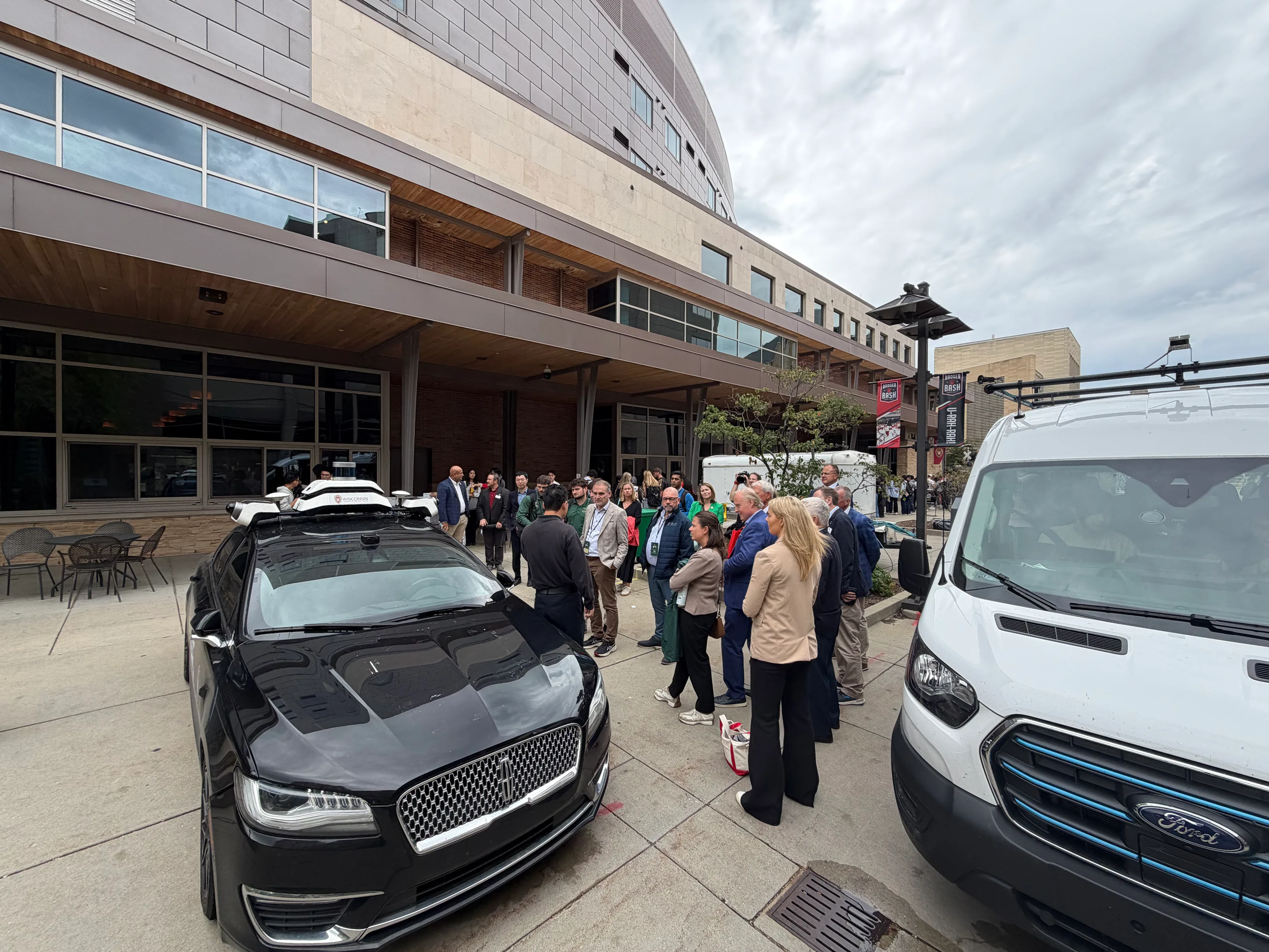 Irish delegation gathered beside the College of Engineering's connected and autonomous research vehicles