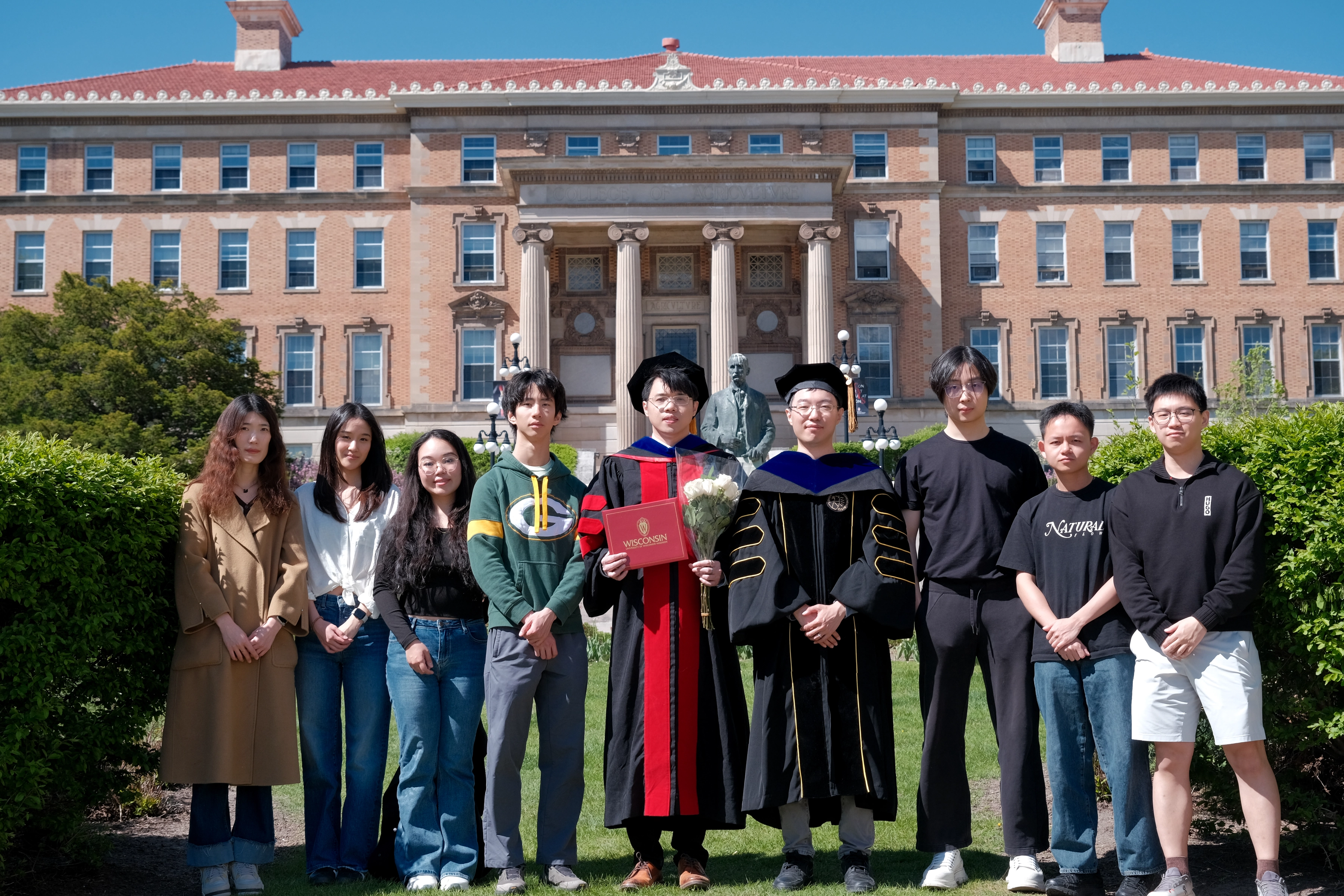 Zilin Huang with friends outside Engineering Hall after commencement