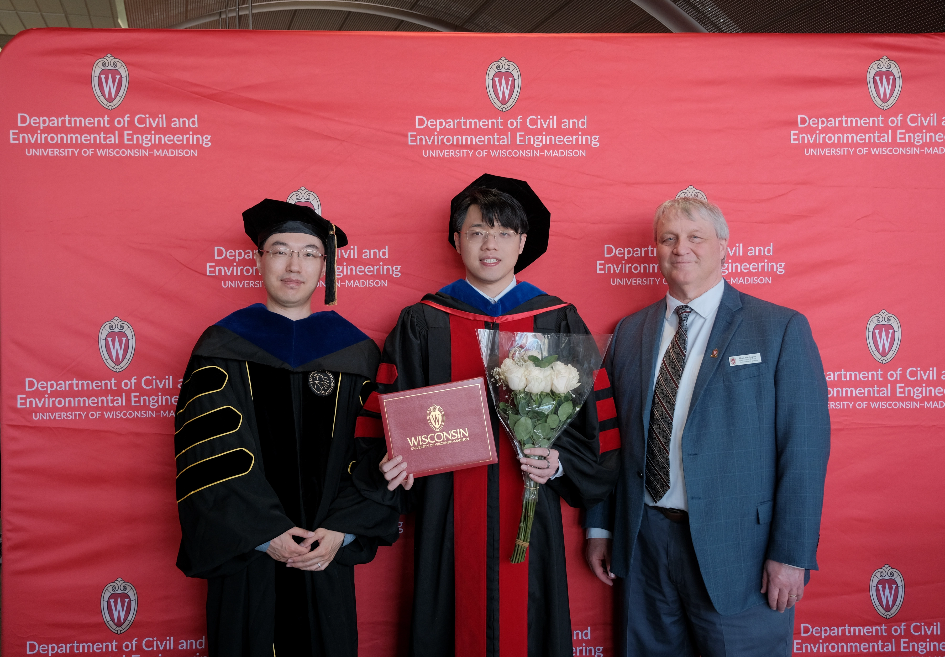 Zilin Huang with faculty members at the UW–Madison CEE commencement