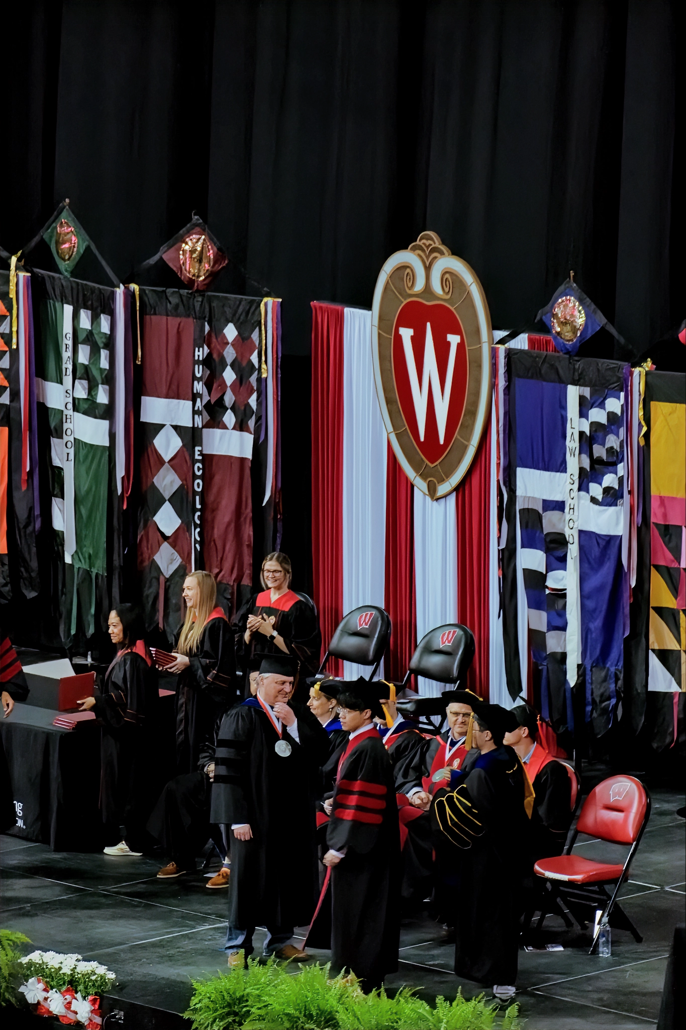 Doctoral hooding on stage at UW–Madison
