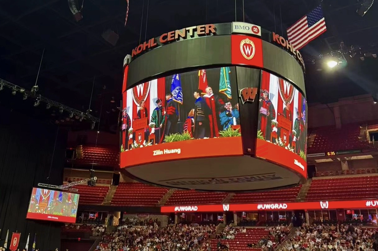 Kohl Center video board showing Zilin Huang during commencement