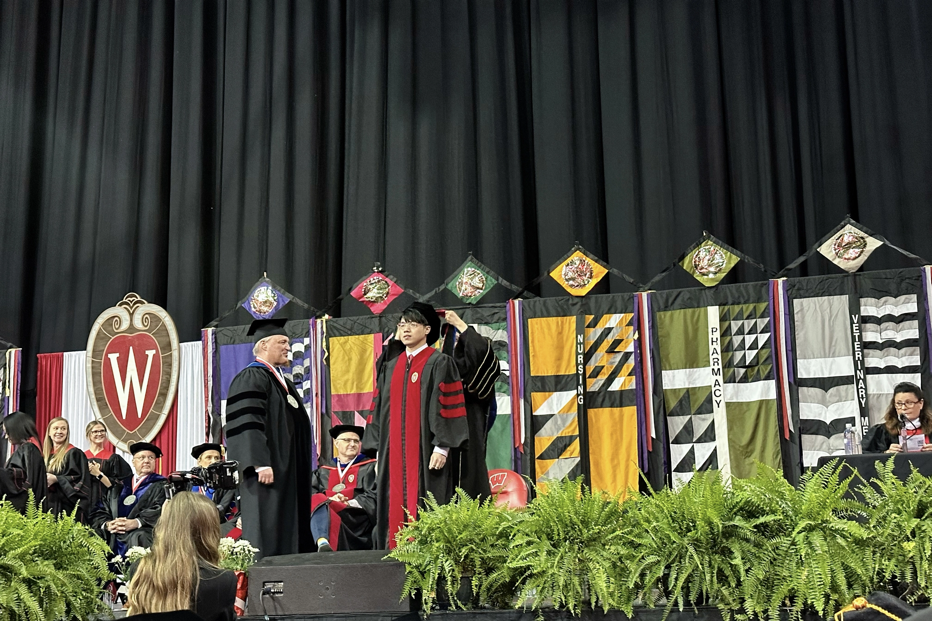 Zilin Huang crossing the commencement stage at UW–Madison