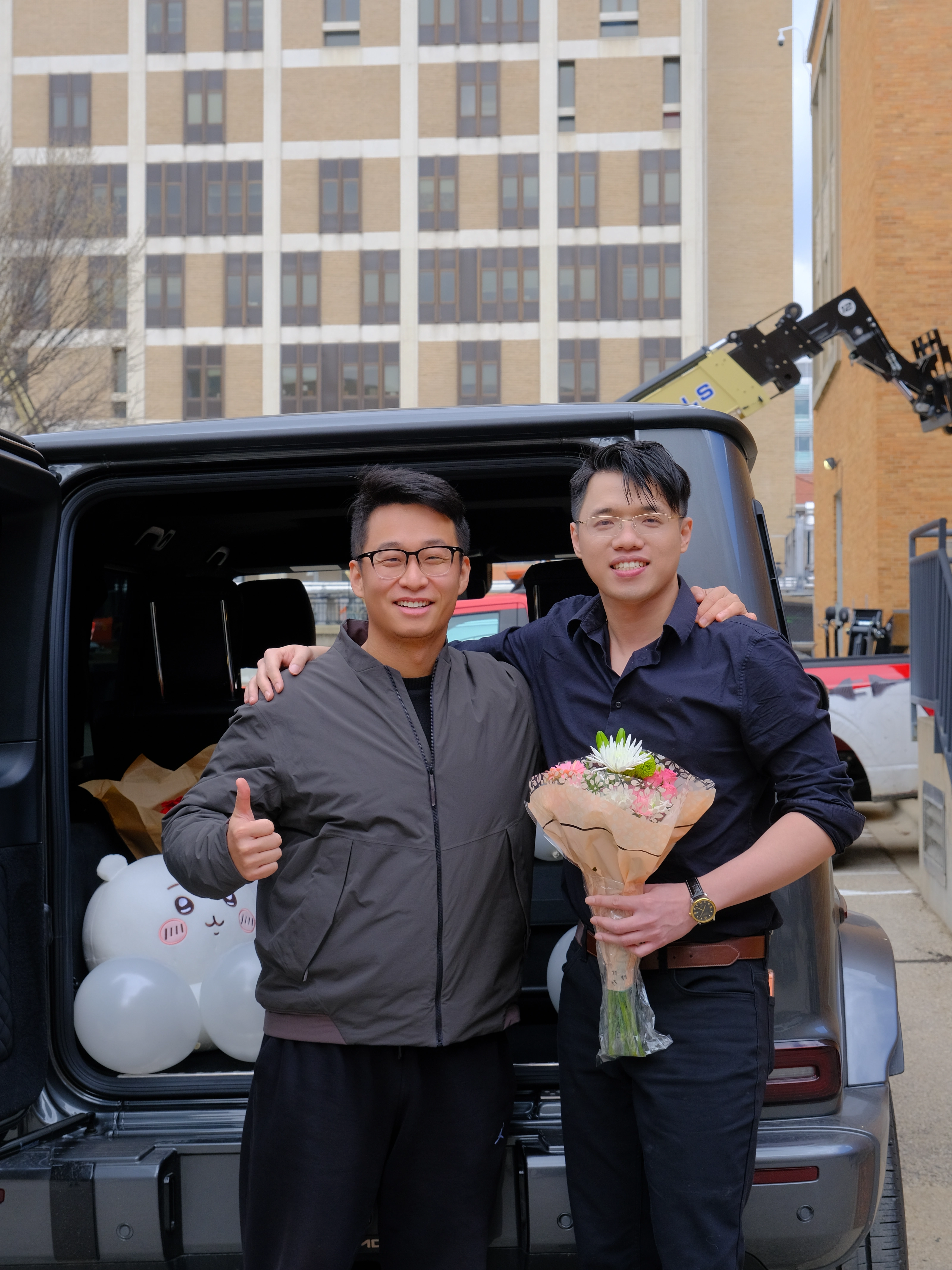 Zilin Huang celebrating his Ph.D. defense with a friend