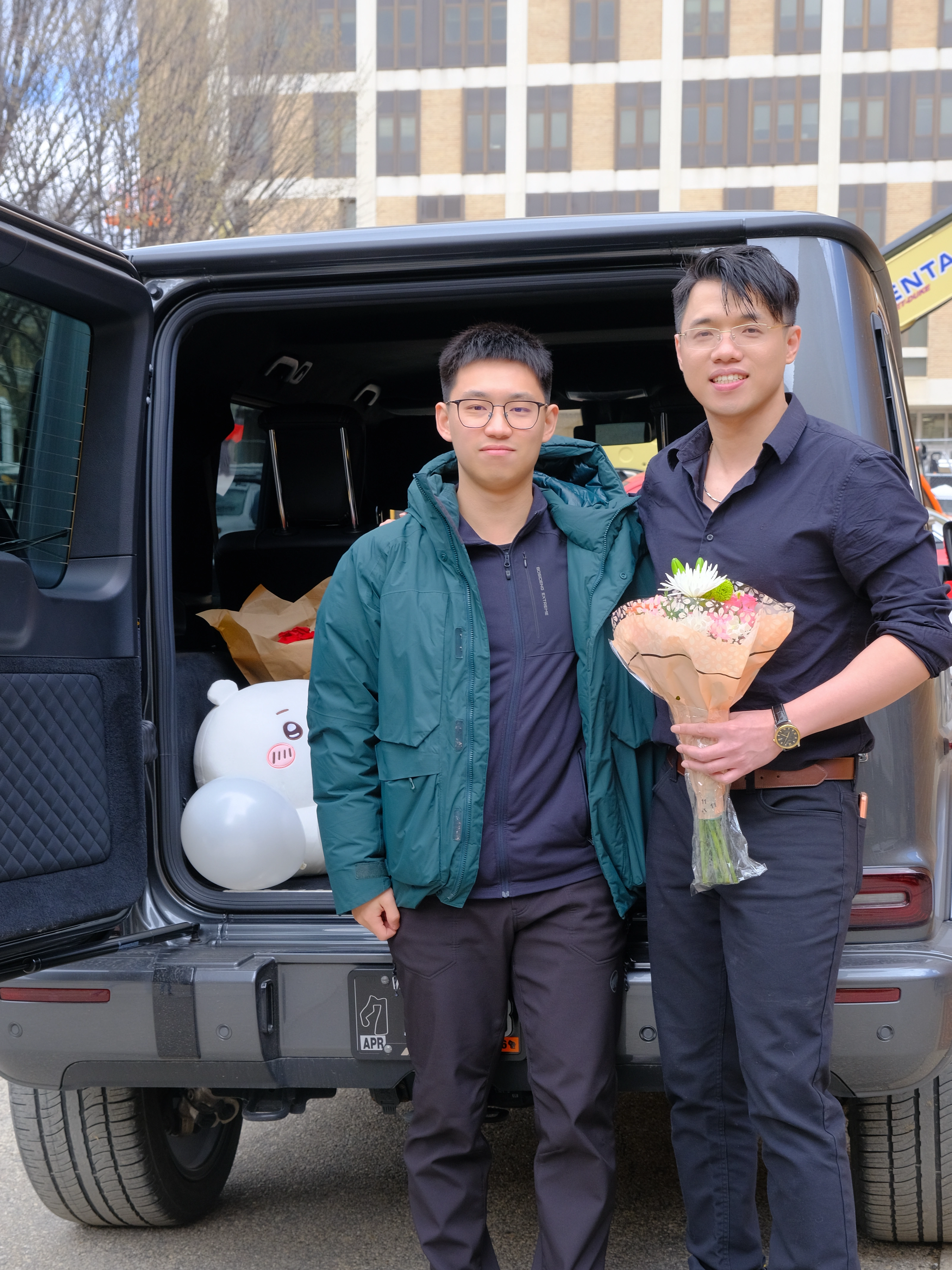 Zilin Huang celebrating his Ph.D. defense with a friend