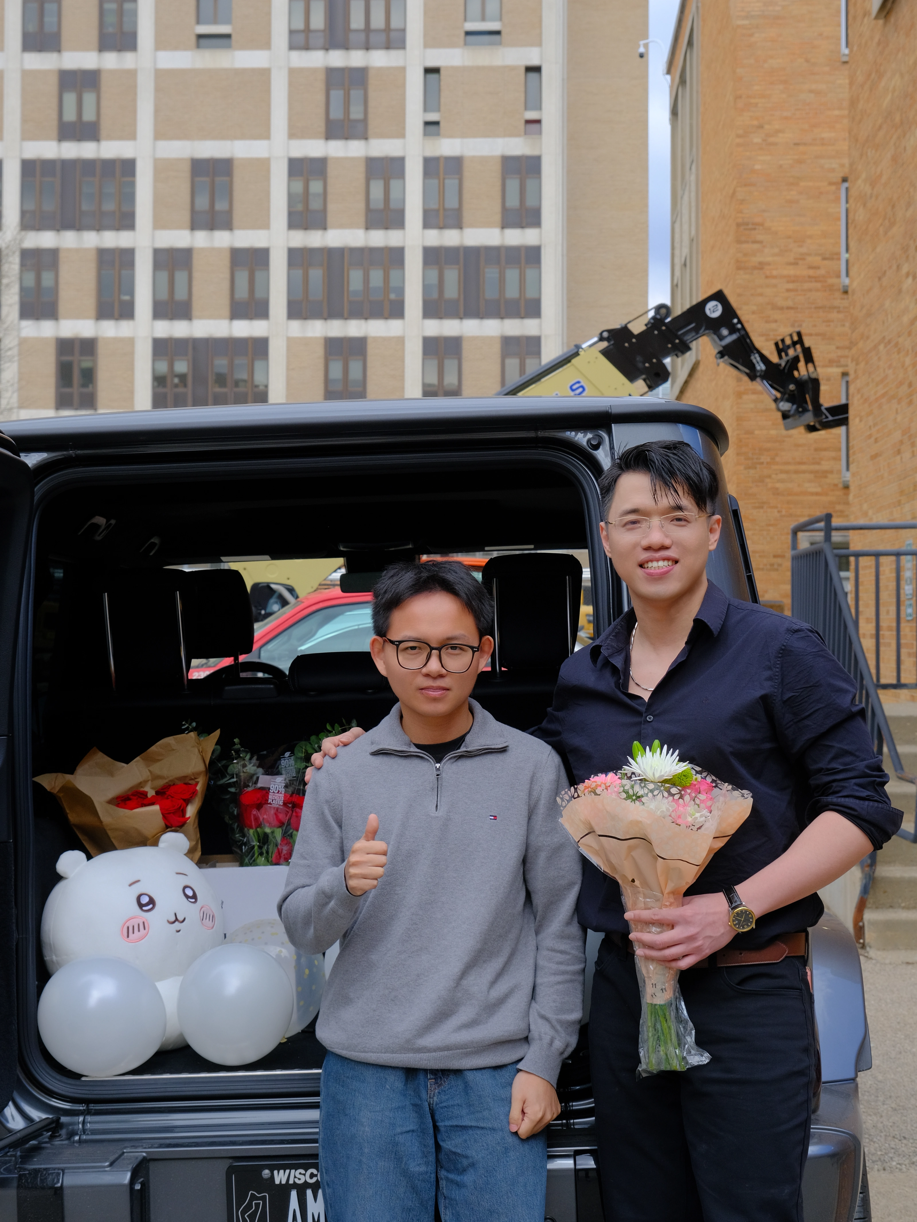 Zilin Huang celebrating his Ph.D. defense with a friend