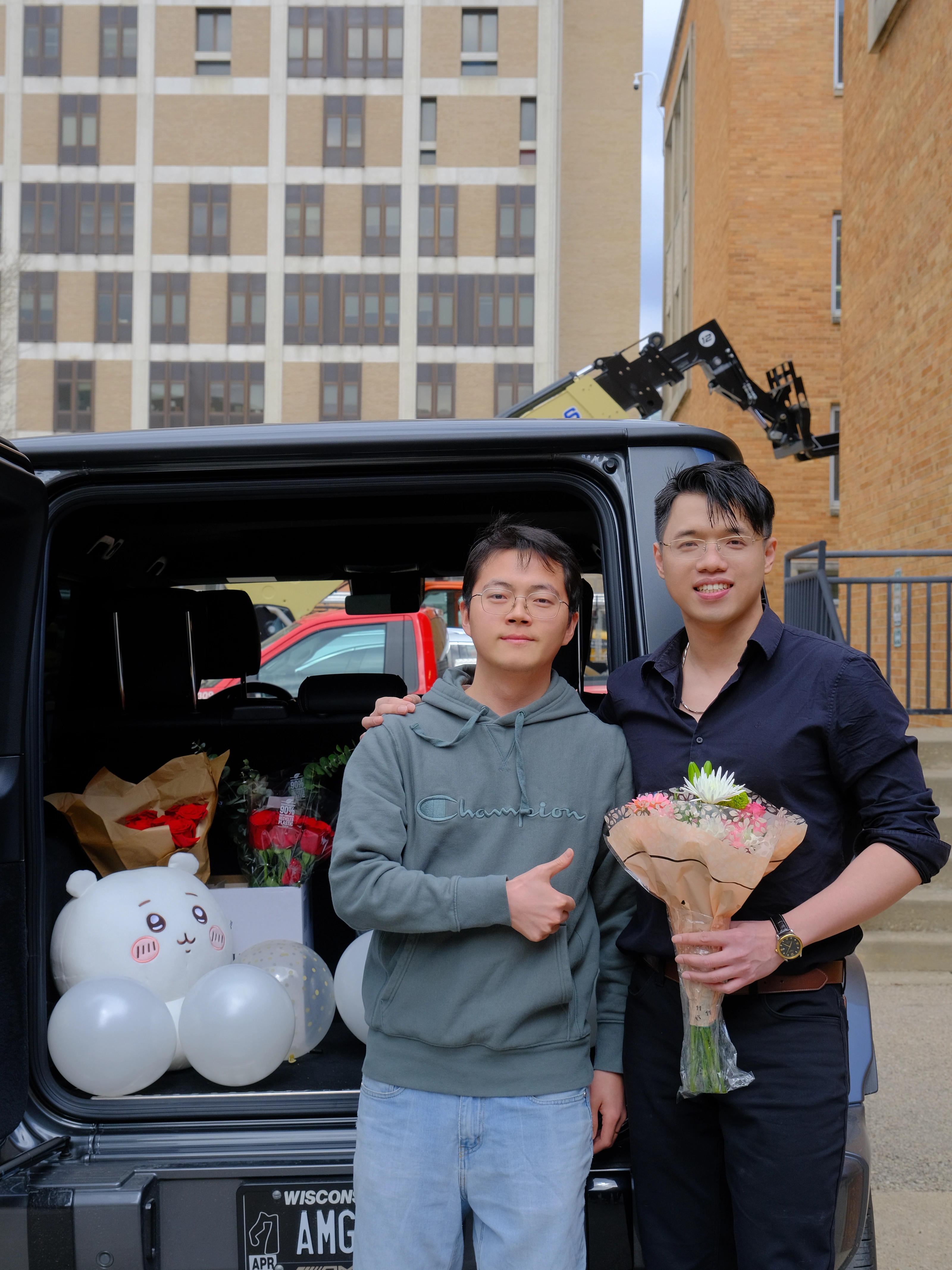 Zilin Huang celebrating his Ph.D. defense with a friend