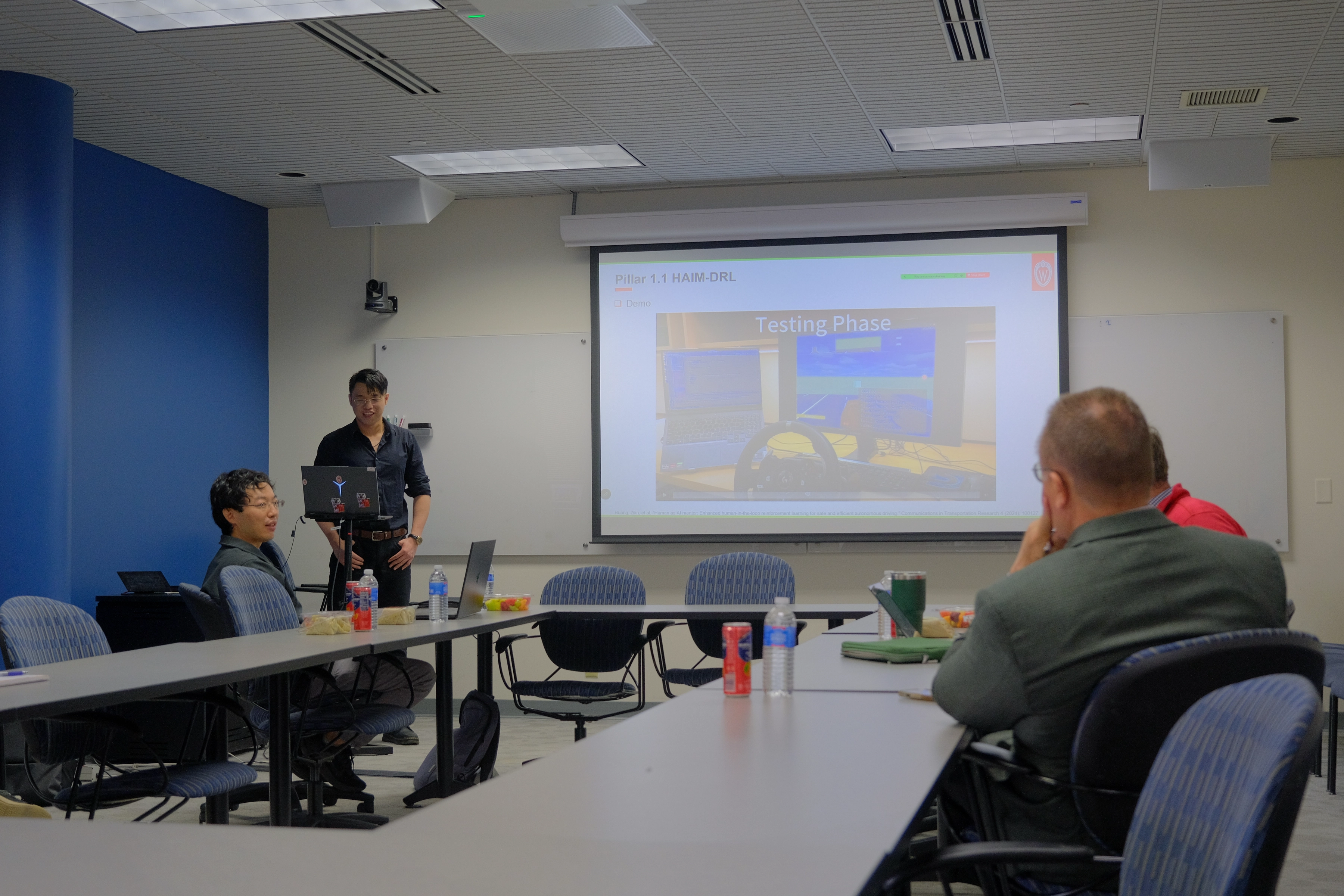 Zilin Huang discussing autonomous driving system evaluation during his Ph.D. dissertation defense