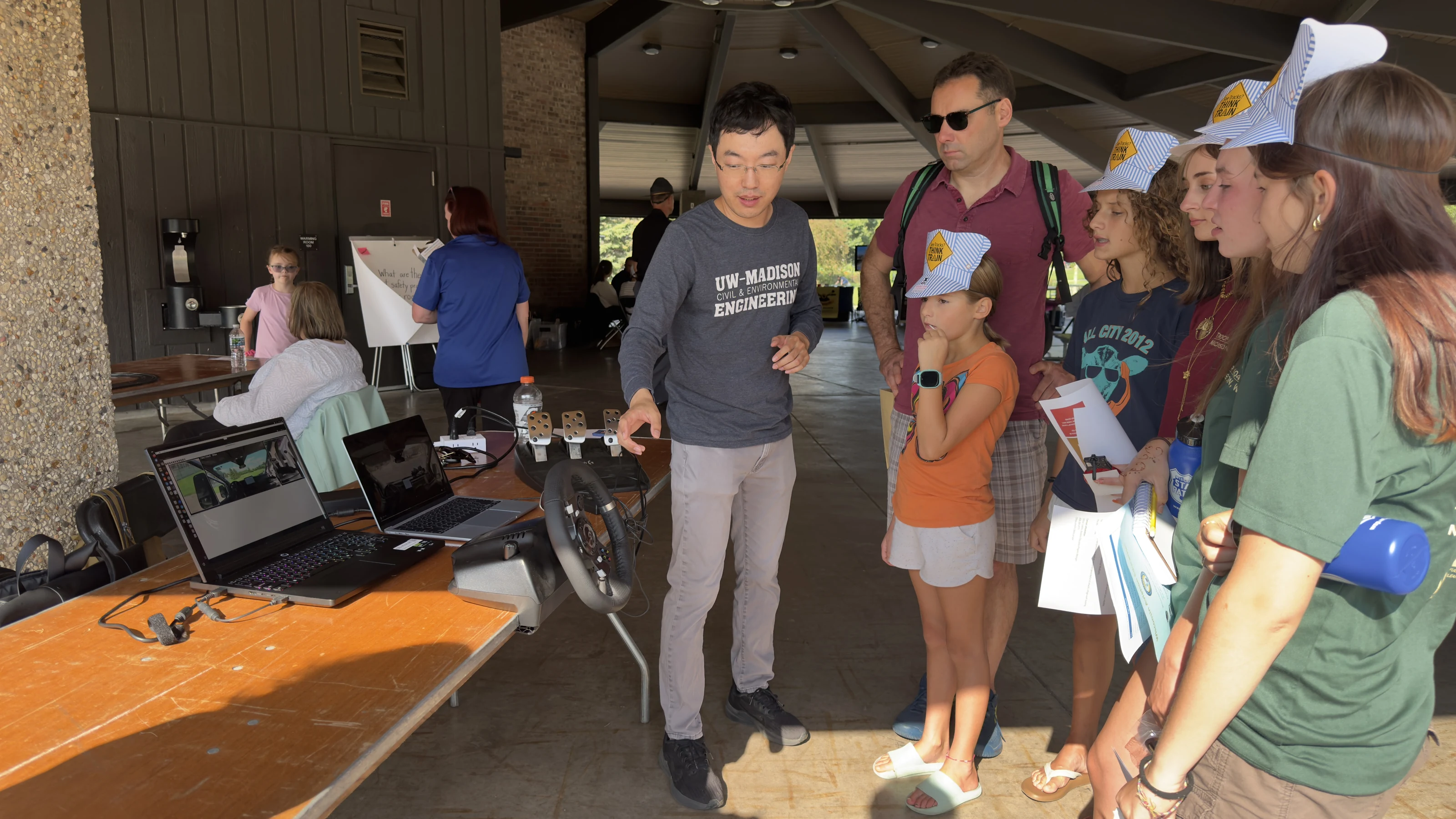 Families watching a hands-on remote-driving demonstration