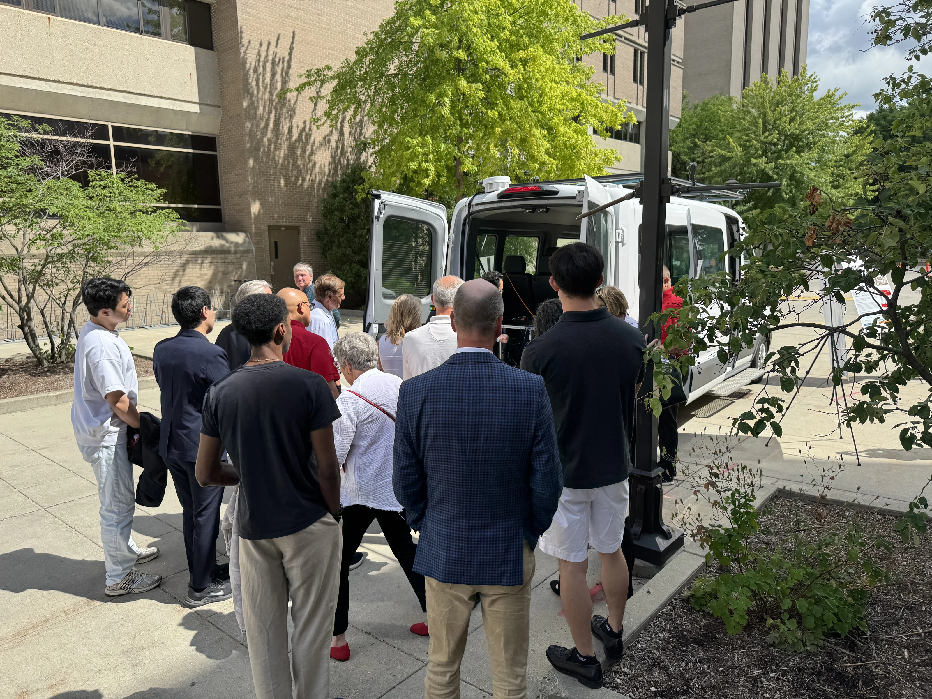Guests examining the autonomous shuttle during the WFAA demonstration